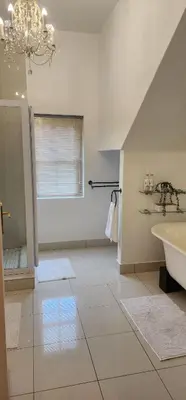 a white bathroom with a sink and a tub at Stellenbosch Paradijs Cottage Paradyskloof in Stellenbosch