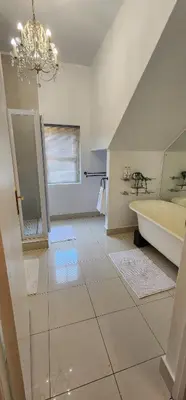 a bathroom with a sink and a tub and a mirror at Stellenbosch Paradijs Cottage Paradyskloof in Stellenbosch
