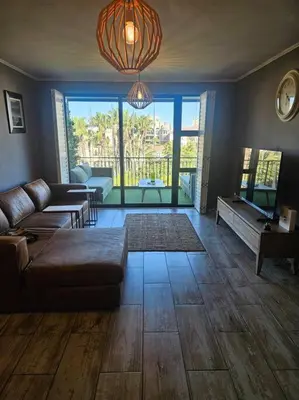 a living room with a couch and a table at SS Luxury Apartments Island Club in Cape Town
