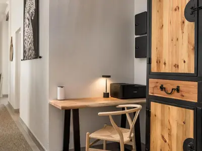 a room with a wooden desk and a chair at Phezulu Manor, Panoramic Views, Serviced Retreat in Gordonʼs Bay