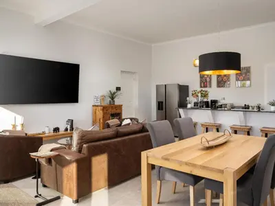 a living room with a couch and a table at Phezulu Manor, Panoramic Views, Serviced Retreat in Gordonʼs Bay