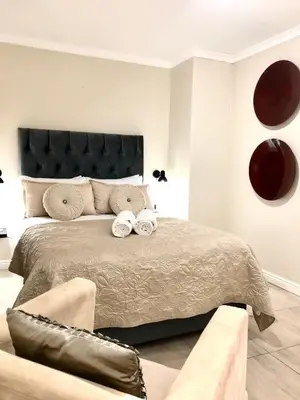 a bedroom with a large bed with two towels at The Perfect Cape Town Retreat in Cape Town