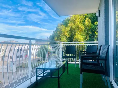 a balcony with two chairs and a table on a balcony at The Perfect Cape Town Retreat in Cape Town