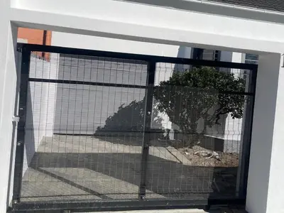 a dog in a cage in a window at Optimum Stay Self Catering Accommodation - Deluxe Room in Cape Town