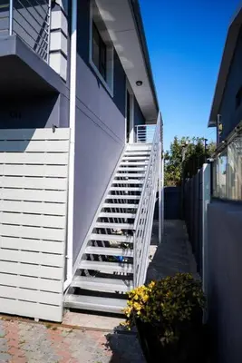 a stairway leading up to a building with a white staircase at Luxurious 4 bedroom Family Home in Cape Town