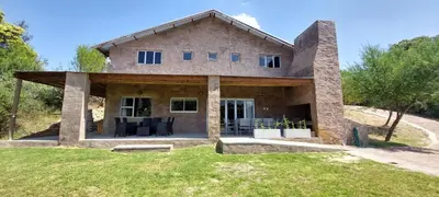 a house on a hillside with a patio at Riverbank in Tulbagh