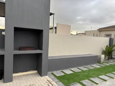 a wall with a bench on the side of a house at Modern 3 bedroom Urban Getaway in Cape Town