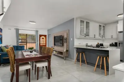 a kitchen and dining room with a table and chairs at Tafelzicht Peaceful Retreat - Wifi - Netflix in Cape Town
