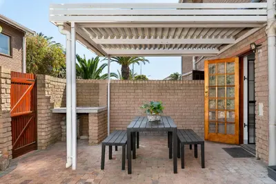 a white pergola with a table and chairs on a patio at Tafelzicht Peaceful Retreat - Wifi - Netflix in Cape Town