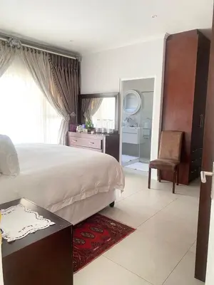 a bedroom with a bed and a desk and a chair at Five bedrooms holiday home in Cape Town