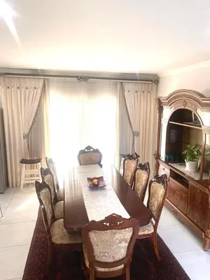 a dining room with a table and chairs at Five bedrooms holiday home in Cape Town