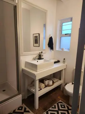a white bathroom with a sink and a toilet at No 4 Life at Sea in Strand
