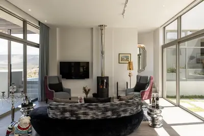 a living room with a large couch and chairs at Azure Retreat in Hermanus