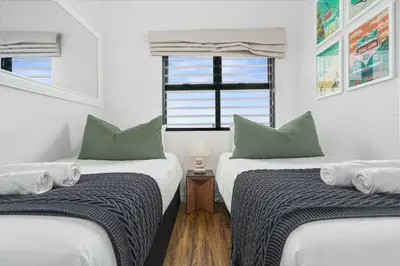 two twin beds in a room with a window at Atlantic Port 10 by Host Agents in Cape Town
