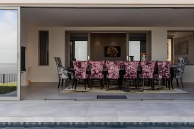 a dining room with a table and chairs at Oceanique in Hermanus