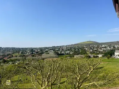 a view of a city from a hill with trees at Divine View in Cape Town