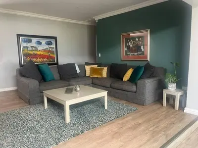 a living room with a couch and a coffee table at Divine View in Cape Town