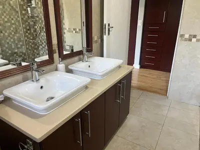 a bathroom with two sinks and a large mirror at Divine View in Cape Town