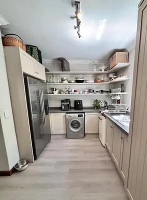 a kitchen with a refrigerator and a dishwasher at Garden oasis in the village in Franschhoek