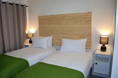 two beds sitting next to each other in a hotel room at Camden Stay - Entire Unit - Cape Town in Cape Town