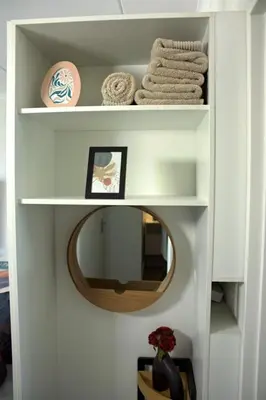 a bathroom with a mirror and towels on shelves at Camden Stay - Entire Unit - Cape Town in Cape Town