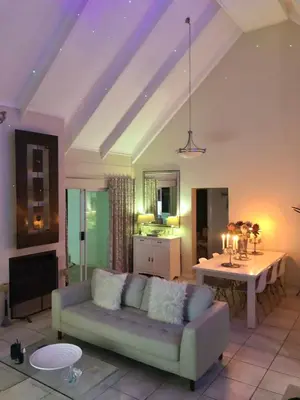 a living room with a couch and a table at #SilverSands Coastal Retreat in Betty's Bay in Bettyʼs Bay