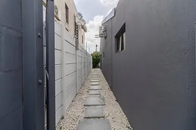 an alley between two buildings with at 1Bed Flat, Braai, AC, Walking Distance from Blouberg Beachfront in Cape Town