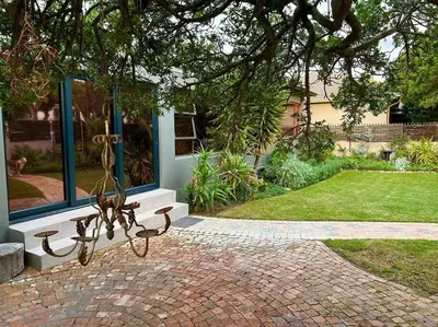 a bench sitting in front of a building at Cosy Home with an Ocean Breath! in Cape Town