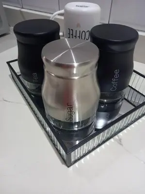 a tray with three containers and a candle on a counter at Entire Spacious Guest suite in Cape Town in Cape Town