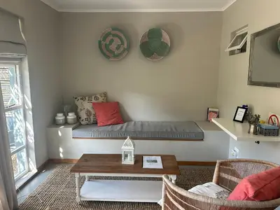 a living room with a couch and a table at Eight on Tuin in Franschhoek