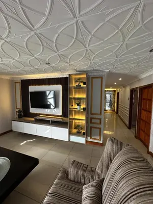 a living room with a couch and a tv on a ceiling at Luxurious 4 bedroom Family Home in Cape Town