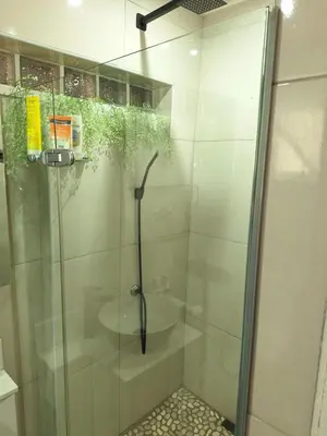 a glass shower stall with a sink in a bathroom at Cosy Cottage Cape Town in Cape Town