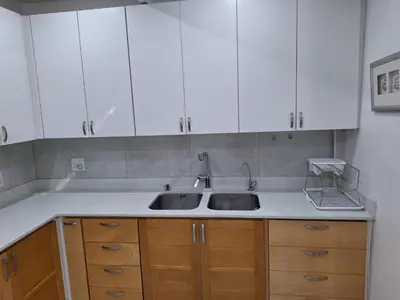 a kitchen with white cabinets and a sink at Cosy Cottage Cape Town in Cape Town