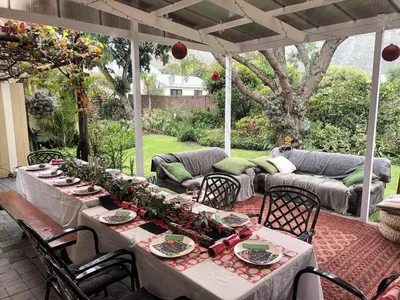 a table set for a meal on a patio at Voëlklip Holiday Home in Hermanus