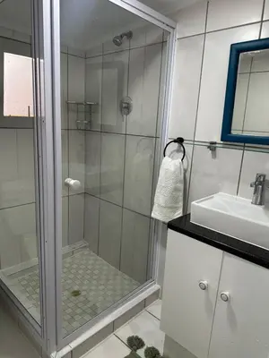 a bathroom with a shower and a sink at Casa on Alamein in Cape Town