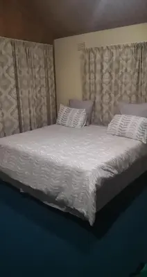 a bed with white sheets and pillows in a bedroom at Transvaal Road, N1 in Worcester