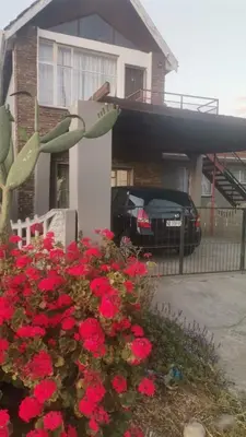 a house with a bunch of red flowers in a yard at Transvaal Road, N1 in Worcester