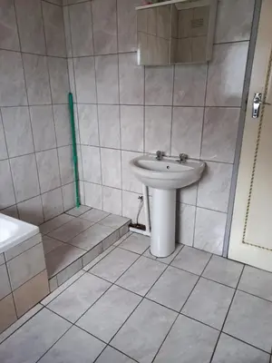 a white bathroom with a sink and a shower at Transvaal Road, N1 in Worcester