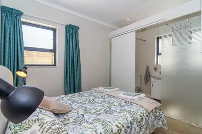 a bedroom with a bed and a window at SeaB by Top Destinations Rentals in Hermanus