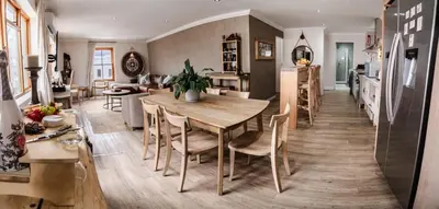 a kitchen and dining room with a table and chairs at Village Artisan Franschhoek in Franschhoek