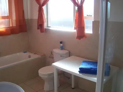 a bathroom with a toilet and a tub and a sink at Getaway Self-Catering Panorama in Panorama
