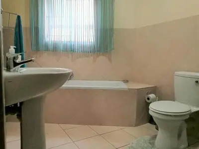 a bathroom with a sink and a toilet and a bath tub at Getaway Self-Catering Panorama in Panorama