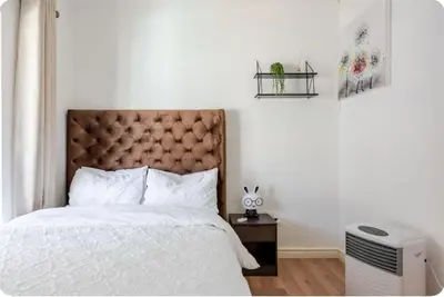 a bedroom with a bed with a large headboard at JDBA Homes of Luxury in Cape Town