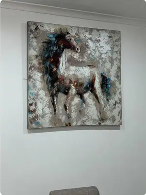 a painting of a horse hanging on a wall at JDBA Homes of Luxury in Cape Town