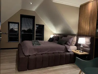 a bedroom with a large bed and a window at YEBO Boutique Guesthouse in Somerset West