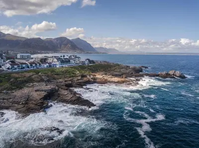 an island in the ocean with houses on a cliff at 111 at The Esplanade in Hermanus