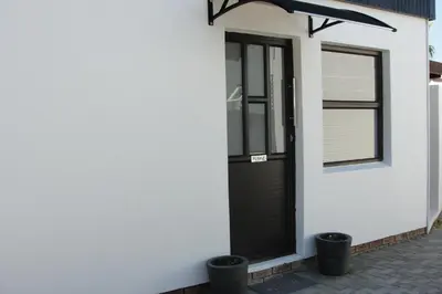 a black door on the side of a house at 113 Reasons Self Catering in Cape Town