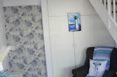 a room with blue and white wallpaper and a stair case at 113 Reasons Self Catering in Cape Town