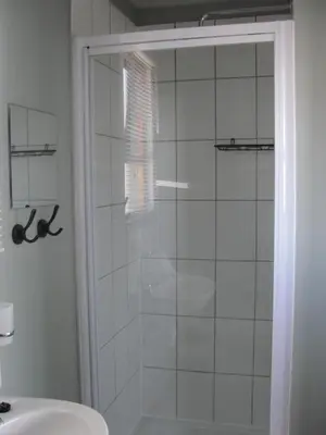 a shower with a glass door in a bathroom at 113 Reasons Self Catering in Cape Town