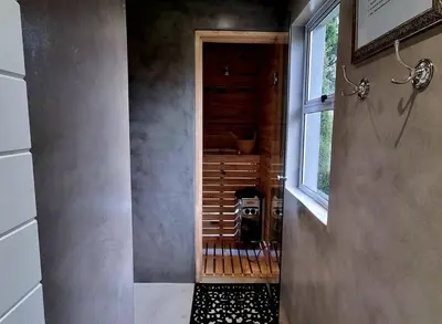 a bathroom with a walk in shower next to a window at C'est la Vie 5 Garden View Apartment in Franschhoek